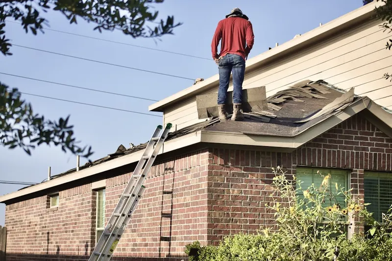 Professional roofer working on a residential roof in The East End